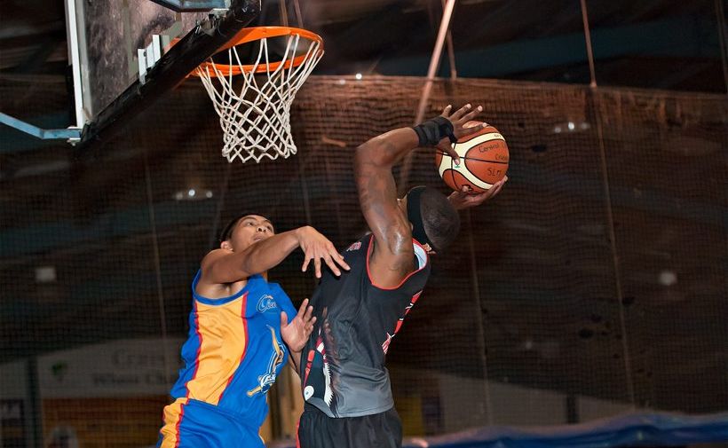 Braves star Ervin Herron flies high to the basket. Braves star Ervin Herron flies high to the basket.